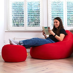 A Woman on Pod with Footstool reading book